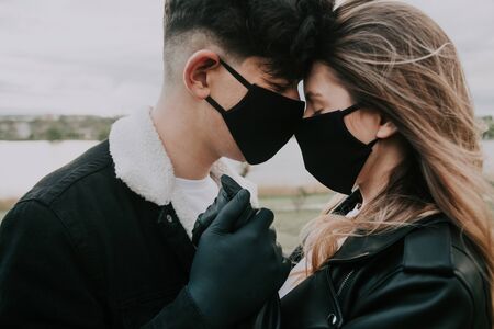 young couple in black medical masks and gloves. safety conceptの写真素材