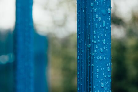 falling water drops on colored metal piece . selective focus .の写真素材
