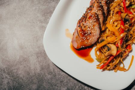meat with barbeque sauce. asian dish with spaghetti and mushrooms  for restaurant menu  top view .の写真素材
