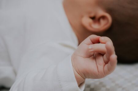 baby hand closeup. gentle hands of a newborn.の写真素材