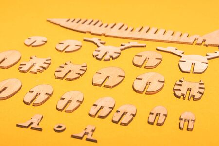 assembled wooden airplane constructor on a yellow background . children spend useful time concept .の写真素材
