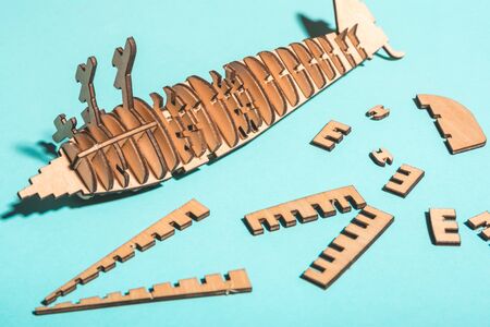 assembled wooden airplane constructor on a blue background . children spend useful time concept .