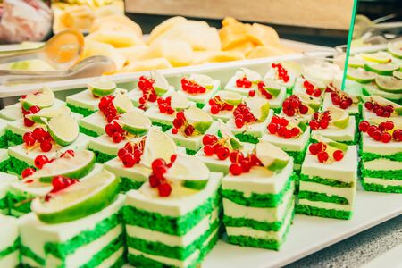 green cake with fruits  on the buffet table in the hotelの写真素材