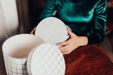 close up girl opens New Year gifts in a cozy home atmosphere
