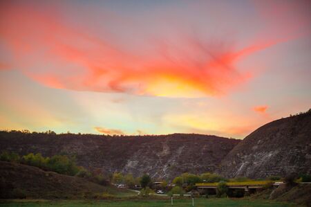 sunset in a village in the mountains fiery skyの写真素材