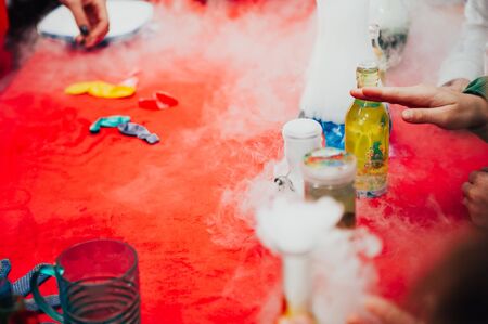 children make volcanoes using steam and dry ice . kids are playing with the animators . hand made diy concept .の写真素材
