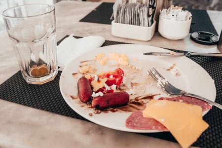 breakfast in hotel. dirty plate with leftover food .の写真素材