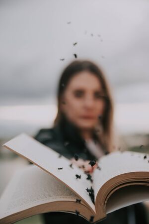 listening mood . flying letters . woman  with book in hand .の写真素材