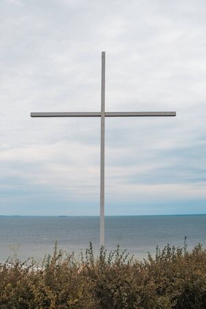 big cross with sea on the background. religion concept and selective focus .の写真素材