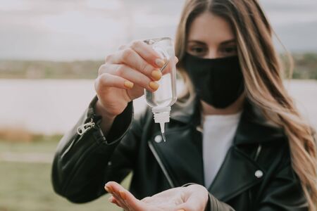 girl shows close up  antiseptic gel in her hand outside . selective focus .