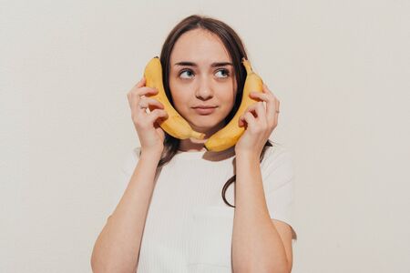 girl talking on bananas thinking that this is a phone . bananaphone cocept .の写真素材