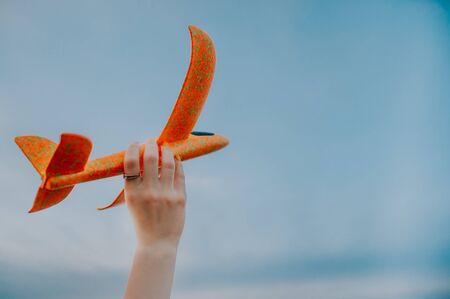 boy playing with orange toy planeの写真素材