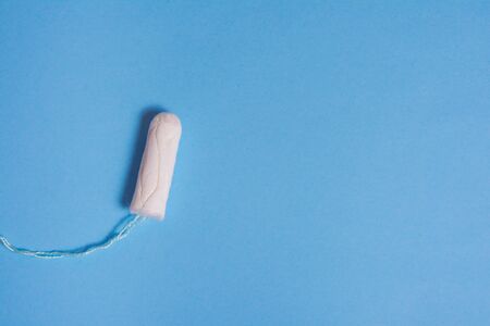 menstruation tampon on blue background . critical days .の写真素材