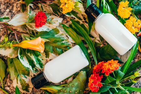 white hotel bath tubes with exotic flowers . travel bottle set mock upの写真素材