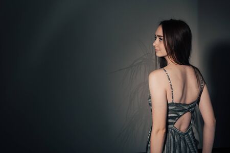 sexy back of a beautiful girl in a black dress with an open back .の写真素材