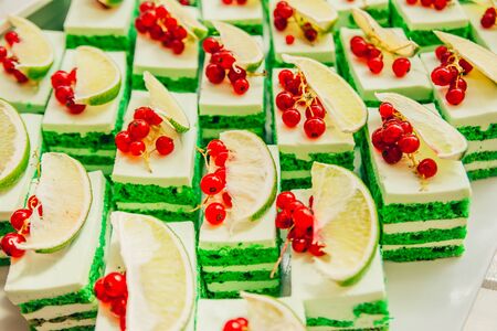 green cake with fruits  on the buffet table in the hotelの写真素材
