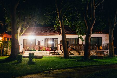 cozy house in the woods at the recreation center at nightの写真素材