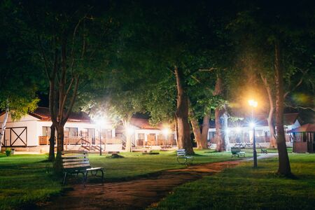 cozy houses in the woods at the recreation center at nightの写真素材
