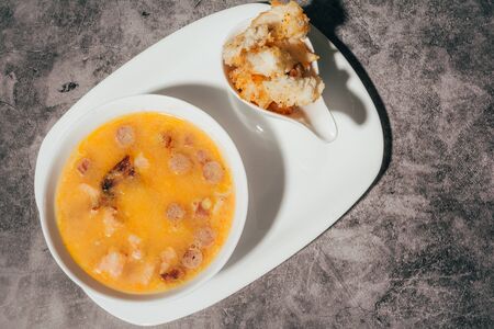 pumpkin soup with croutons on a white plate . top view  .の写真素材