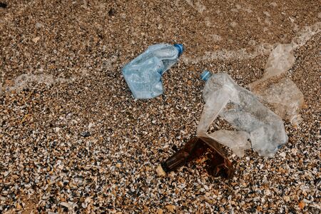 Rubbish plastic disposable bottles  abandoned on sandy beach around the sea . plastic waste pollutionの写真素材
