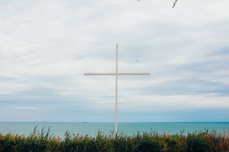 christian cross on a hill in an abandoned place with beautiful views and blue sky  .の写真素材