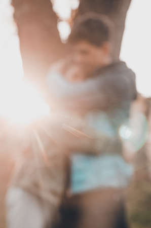 guy and girl hugs in the park.  no focus background .の写真素材