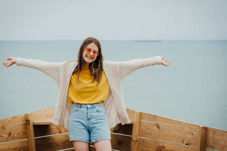 girl smiles on the background of the sea. time to rest concept.の写真素材