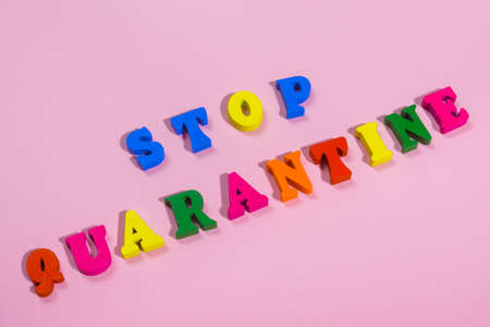 word STOP QUARANTINE made of wood letters.  multi colored tablets around the word   .の写真素材