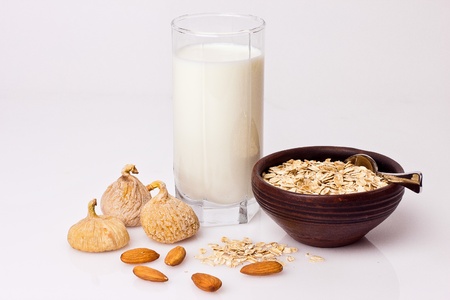Oatmeal,milk,figs and nut on the tableの写真素材