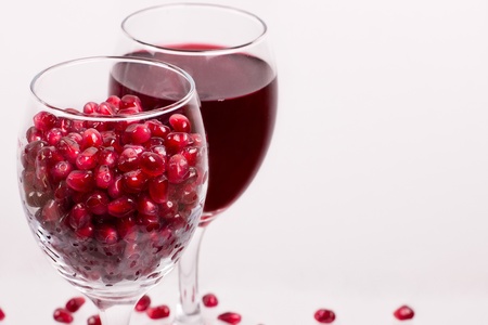 two goblet with pomegranate on the white 