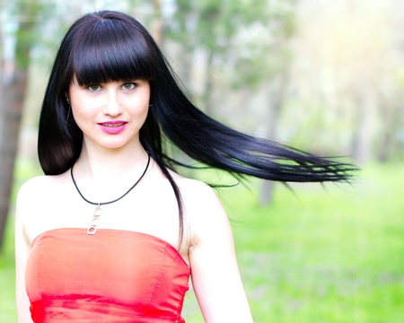 Single beautiful young woman at the parkの写真素材