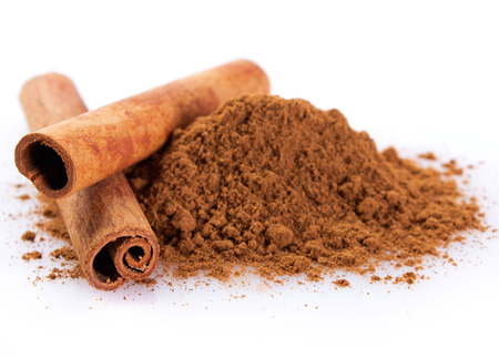 cinnamon sticks with powder isolated on white backgroundの写真素材