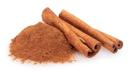 cinnamon stick with powder isolated on white background closeupの写真素材
