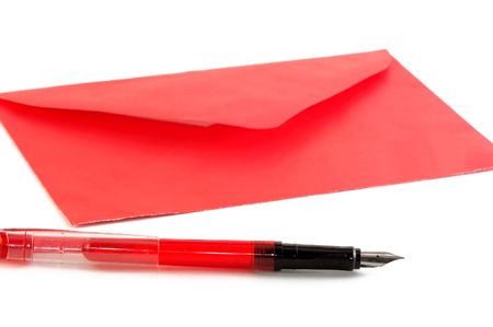 Red envelope and pen isolated on whiteの写真素材