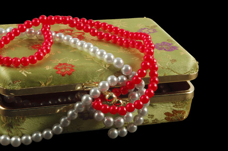 Casket with pearls isolated on blackの写真素材