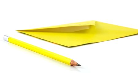 close-ups of yellow envelope and pencil isolated on whiteの写真素材