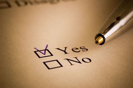 Tickbox with a blue cross on YES an a golden ballpointerの写真素材