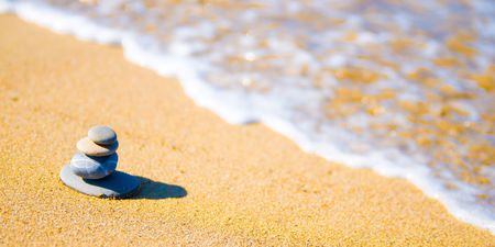 stones stacked up on beachの写真素材