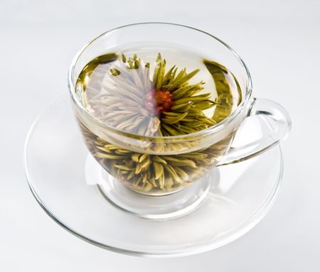 cup with blooming flower green tea の写真素材