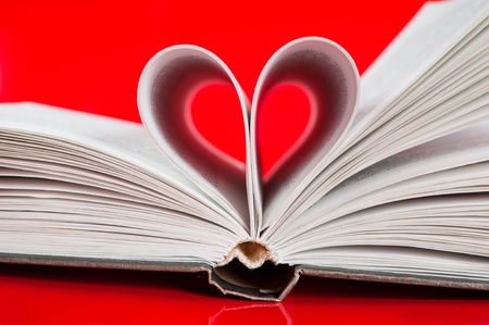 pages of a book curved into a heart shape の写真素材