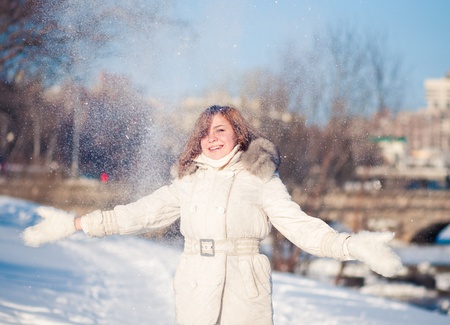 young beautiful woman playing with snow.  の写真素材