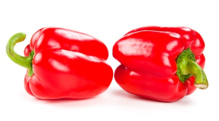 two fresh red peppers on whiteの写真素材