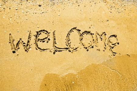 welcome written in a sandy tropical beach の写真素材