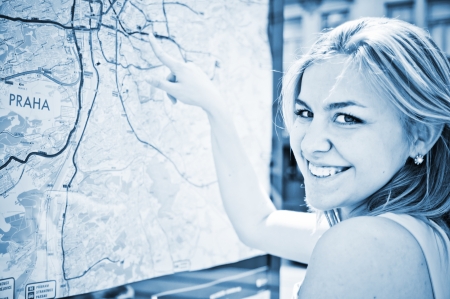 Young woman is looking on a map 
