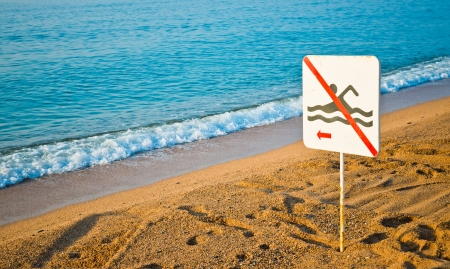 No swimming sign on a beach の写真素材
