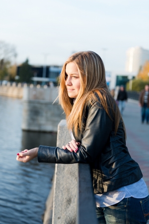 beautiful  woman near fenceの写真素材