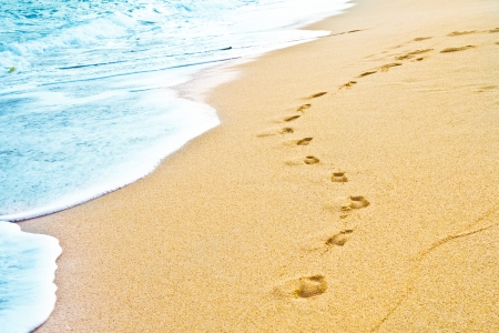 Footprint on sand with foam の写真素材