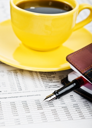 Calculator, cup of coffee and office supplies.の写真素材