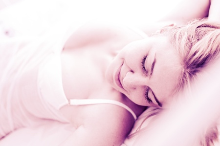 sexy blond woman sleep on bed in lingerie の写真素材
