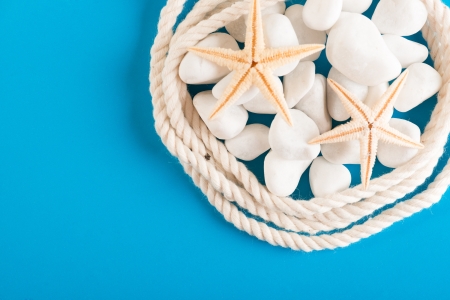 Rope, stones and starfish on blue の写真素材
